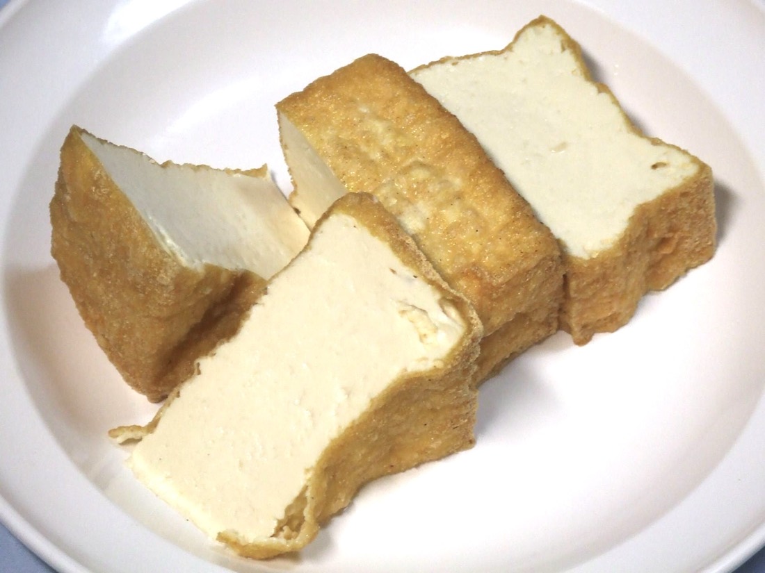 Cut blocks of fried tofu showing a golden skin and pale dense interior